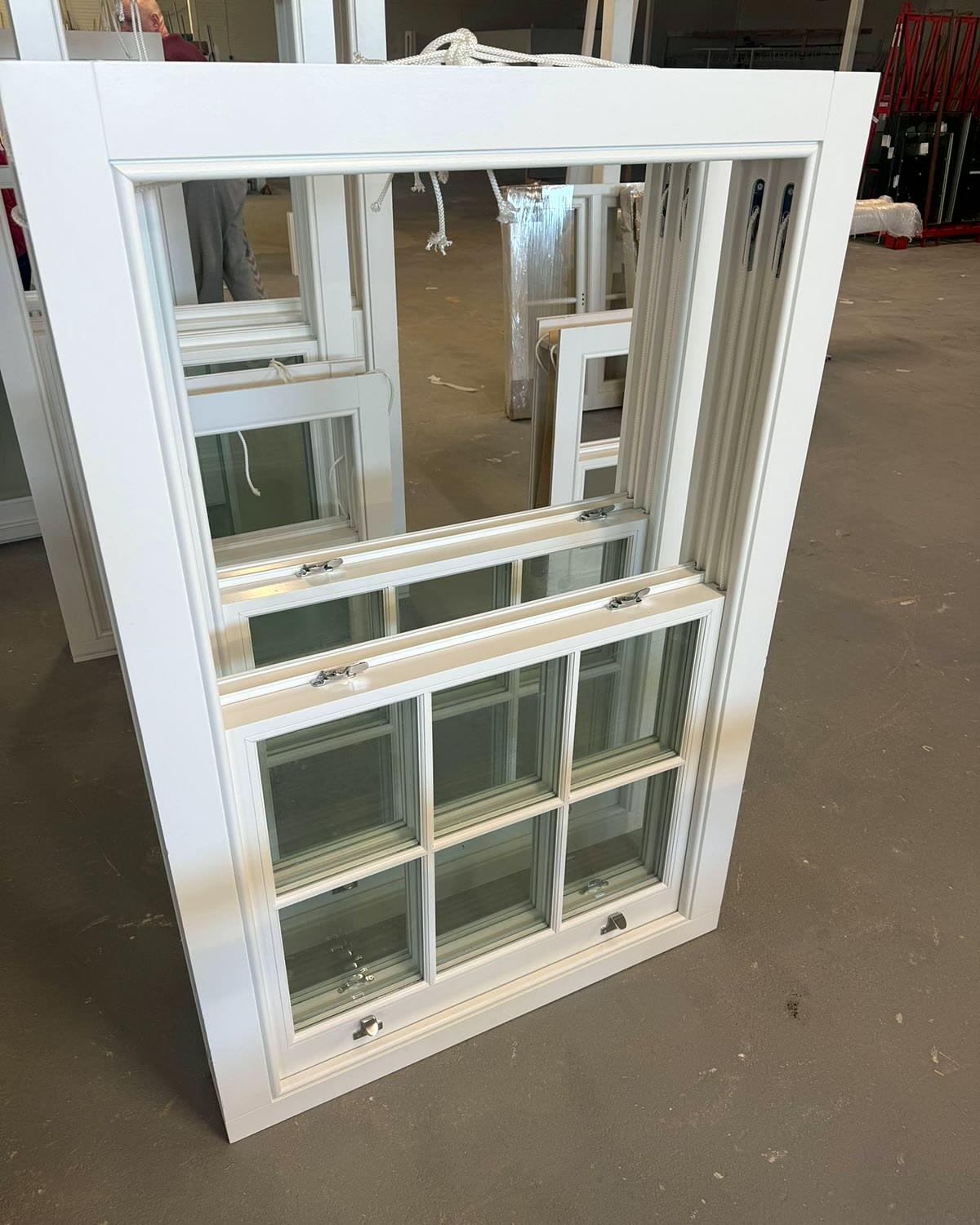 Finished timber sash window with glazing bars and brass fasteners, ready to leave