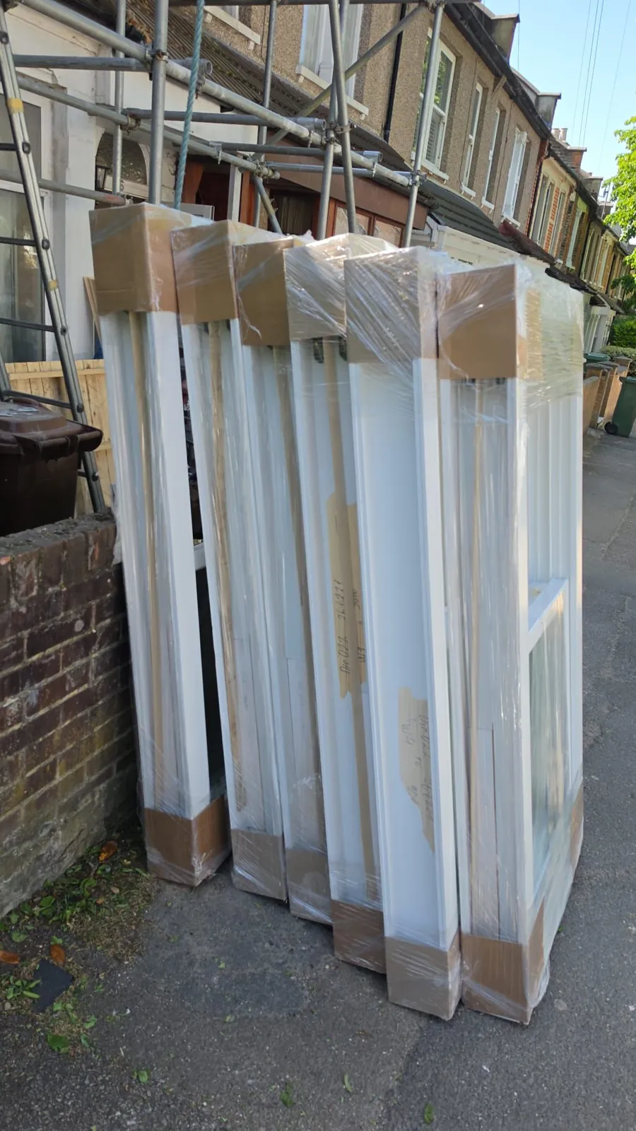 Timber windows wrapped and labelled, ready for UK trade delivery