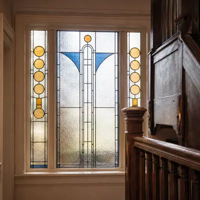 Stained glass timber window on a period staircase landing